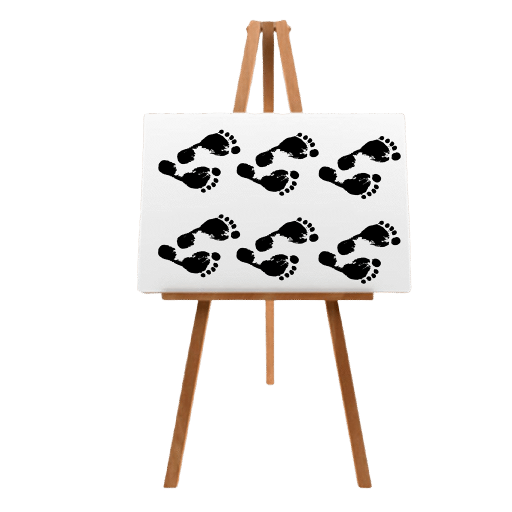 Black acrylic footprints in a repeating pattern on white canvas from Canvas & Curves body painting event